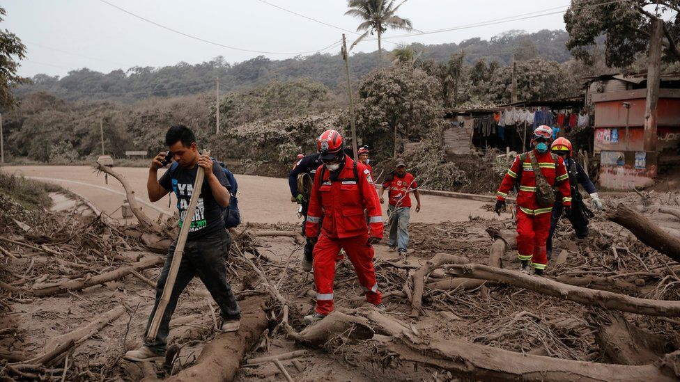 Firefighters tour an area affected by the eruption of the Fuego volcano as they look for bodies or survivors in the community of San Miguel Los Lotes in Escuintla, Guatemala, June 4, 2018