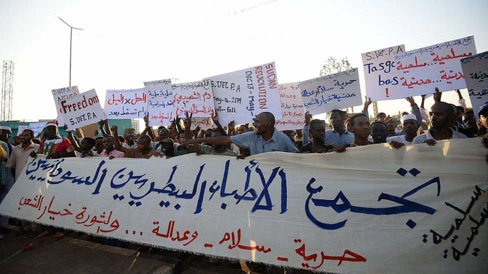 Sudanese protesters chant slogans and wave placards during a demonstration in Khartoum on May 14, 2019