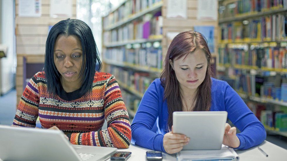 Stock image of students working in a library