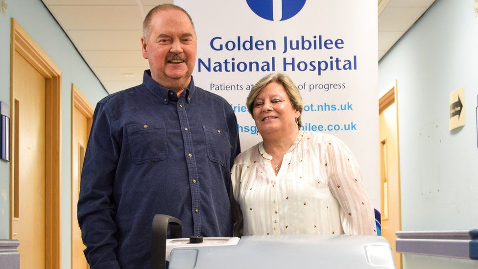 Colin standing next to his wife Susan in the hospital