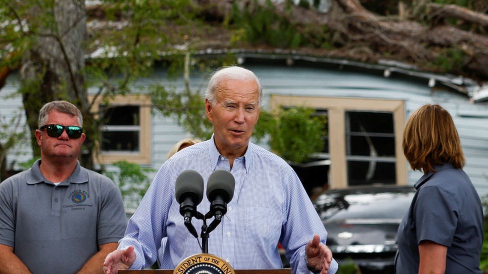 President Joe Biden speaking in front of a house damaged by Hurricane Idalia in the town of Live Oak, Florida