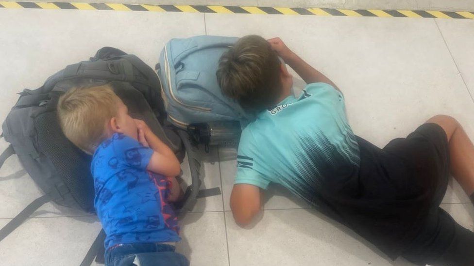 Shayne Quigg's sons on airport floor