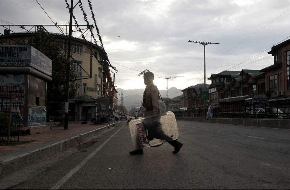 An Indian paramilitary soldier patrols during curfew in Srinagar, Indian-controlled Kashmir, Monday, Aug. 22, 2016.