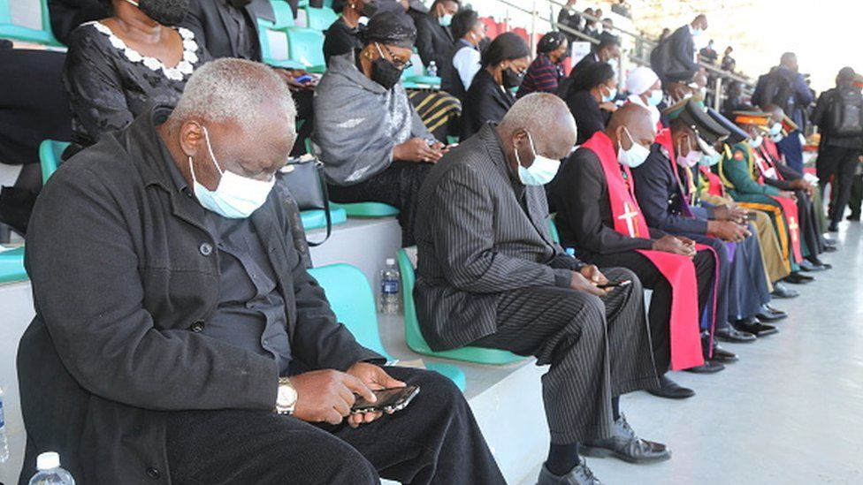 Mourners bow their heads memorial at the service of former Zambian President Kenneth Kaunda