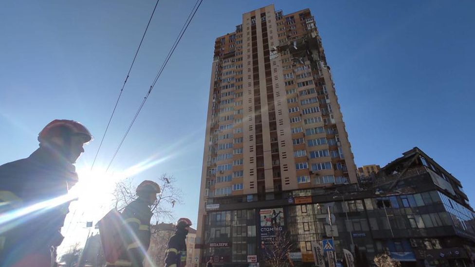 First responders are seen near an apartment building damaged by recent shelling in Kyiv, Ukraine February 26, 2022.