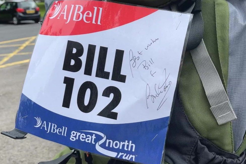 Bill's 102 running number, signed by Brendan Foster