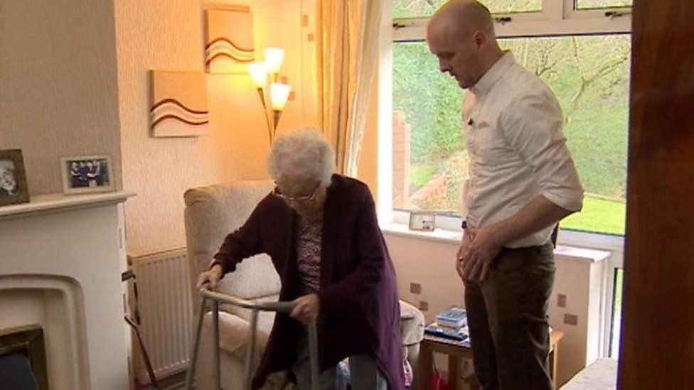 An elderly woman being visited in her home by an occupational therapist