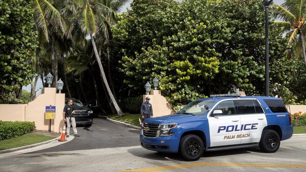 Authorities stand outside Mar-a-Lago, the residence of former president Donald Trump
