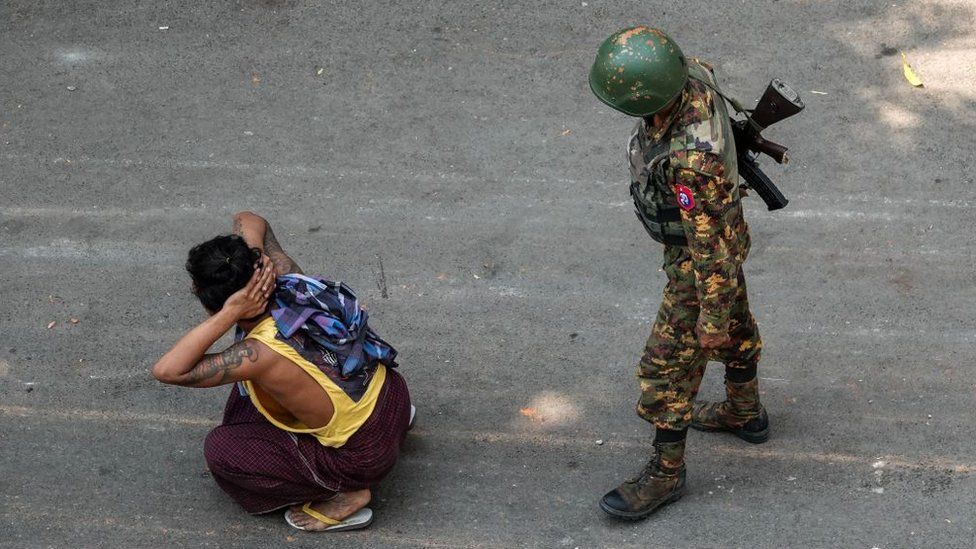 Myanmar soldier with arrested civilian