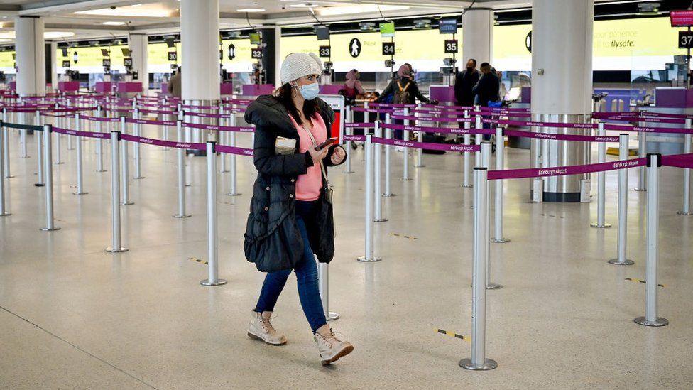 Members of the public are seen at Edinburgh airport as travel corridors close