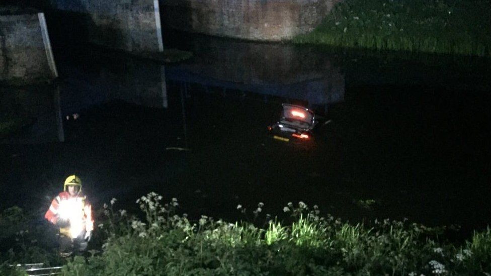 Car being rescued from river