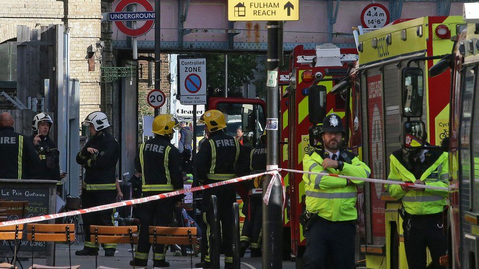 Members of the emergency services work outside Parsons Green underground tube station in west London