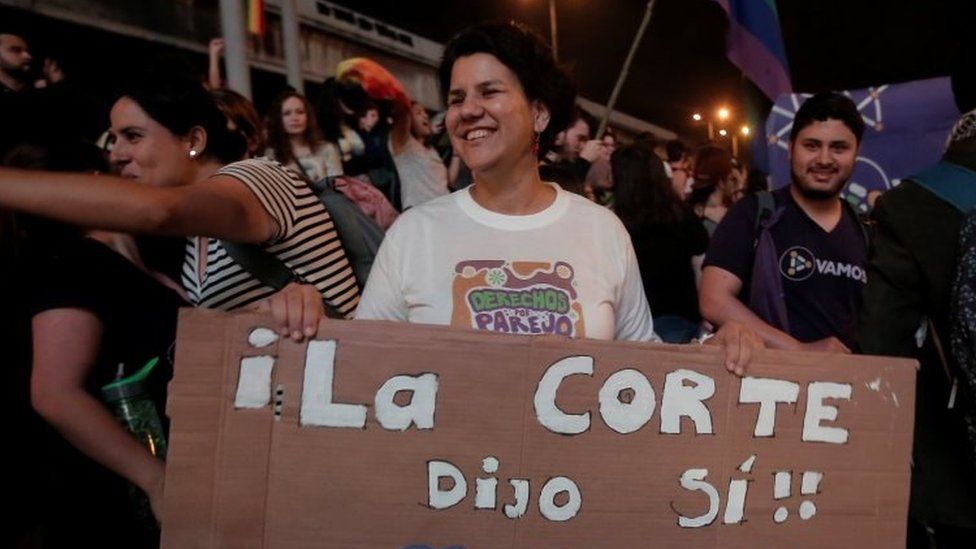 People celebrate after the Inter-American Court of Human Rights called on Costa Rica and Latin America to recognize equal marriage, in San Jose, Costa Rica, January 9, 2018. The sign reads: "The court said yes".