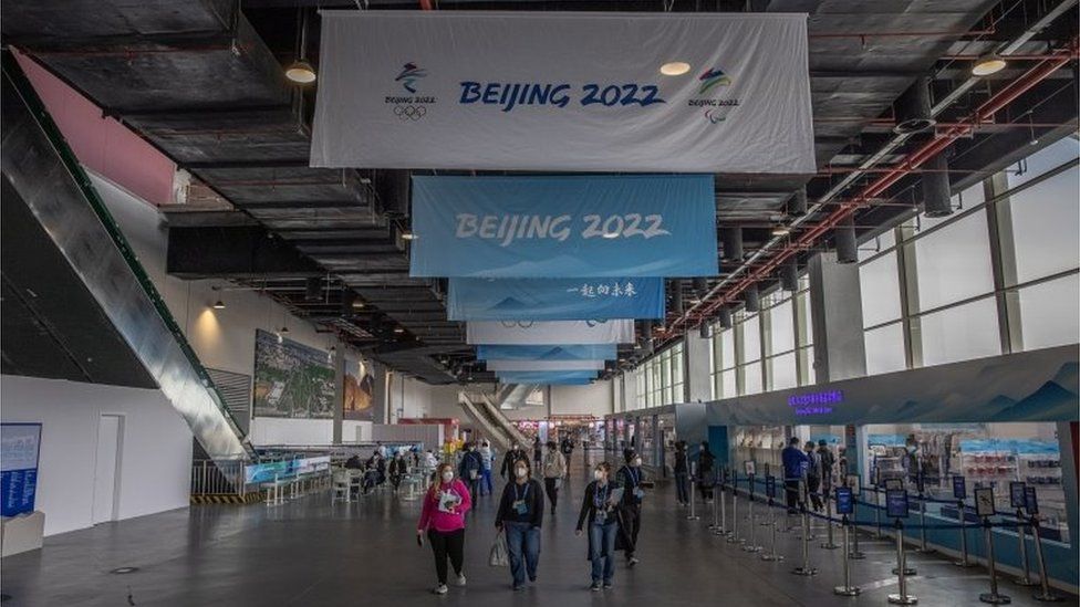 People walk inside the Olympic main media centre, which is part of the Olympic COVID-19 "bubble"