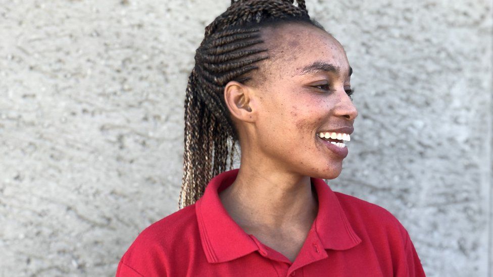 Health worker in red shirt