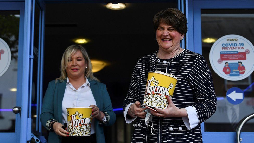 Arlene Foster and Michelle O'Neill with big buckets of popcorn outside the Strand Arts Centre in east Belfast.