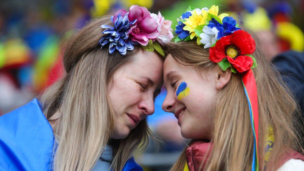 A Ukrainian supporter is consoled by her daughter
