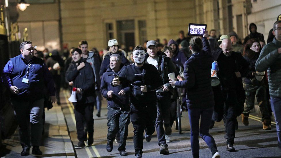 People take part in the Million Mask March anti-establishment protest at Trafalgar Square i