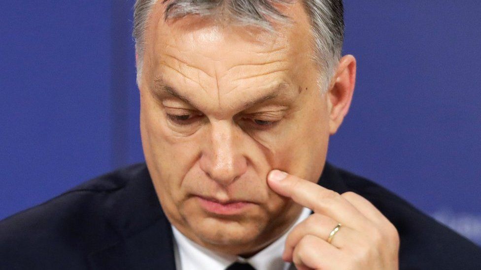 Hungarian Prime Minister Viktor Orban scratches his cheek as he attends a press conference at the end of the European People's Party (EPP) on 20 March
