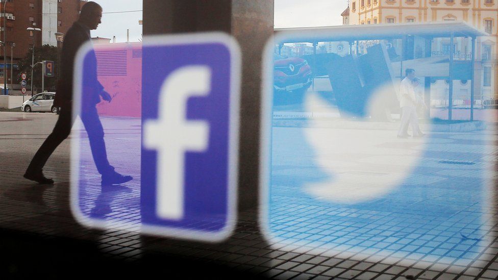 Facebook and Twitter logos on a shop window in Malaga, Spain, 4 June 2018