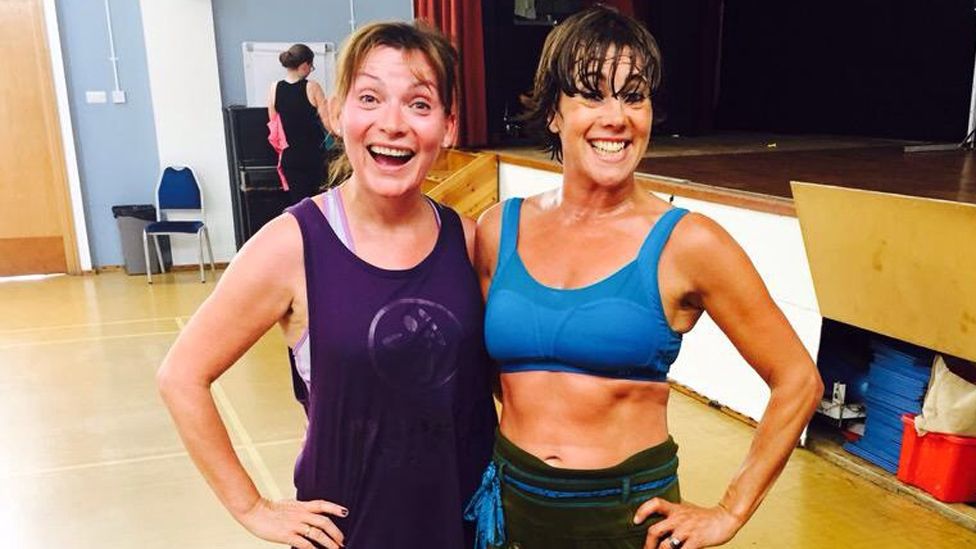 Lorraine Kelly and her trainer doing exercise