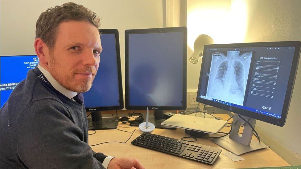 Consultant radiologist Dr James Hathorn sitting in front of a computer showing a chest x-ray
