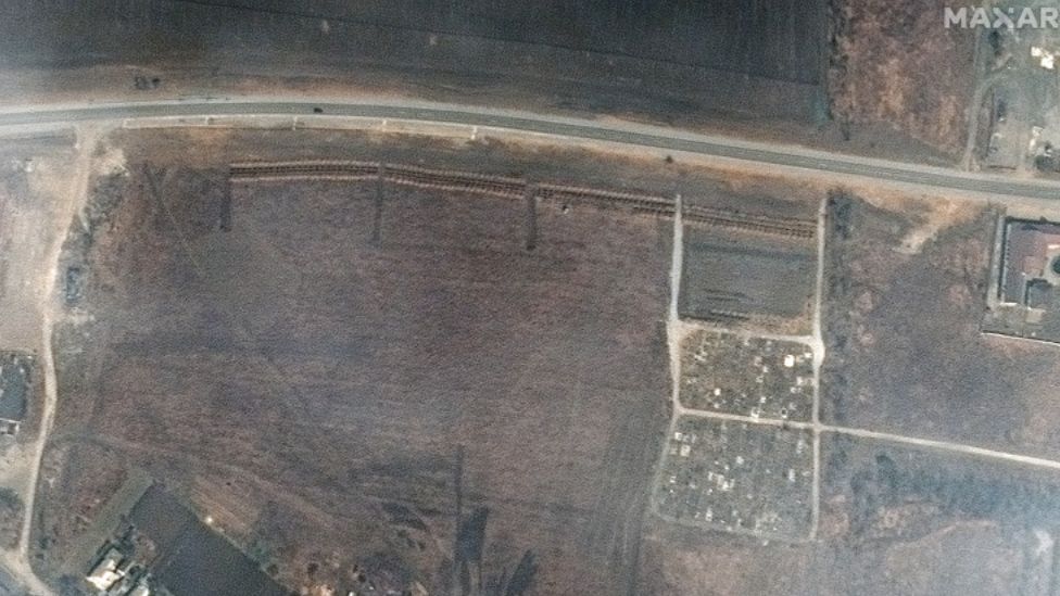 A satellite image by Maxar purportedly showing four sections of linear rows of graves near Mariupol