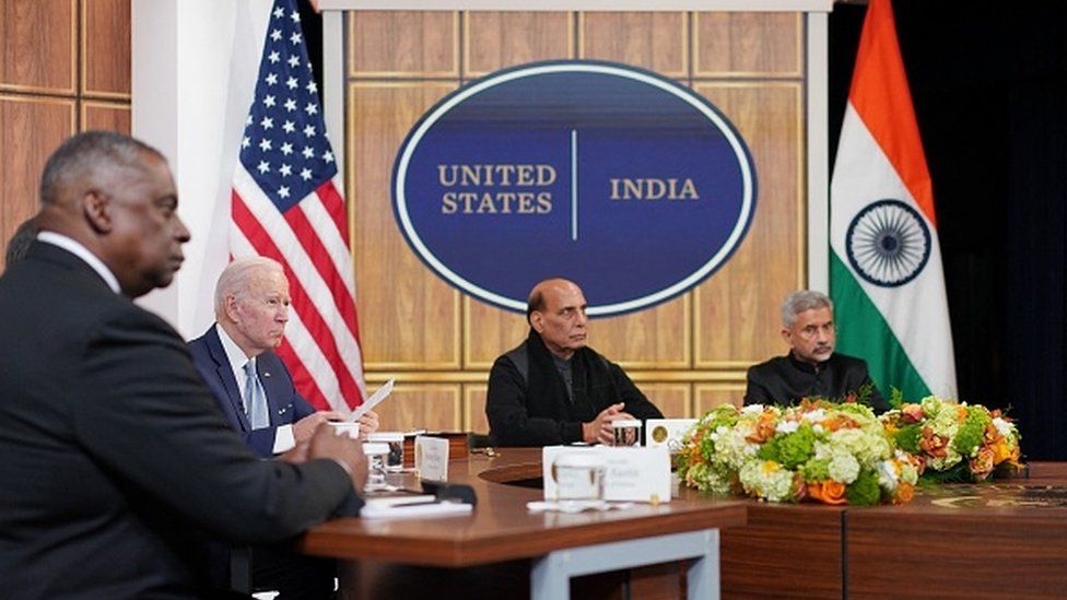 US President Joe Biden (2L), alongside US Secretary of Defense Lloyd Austin (L) and India's Minister of Defense Rajnath Singh (2R), takes part in a virtual meeting with India's Prime Minister Narendra Modi