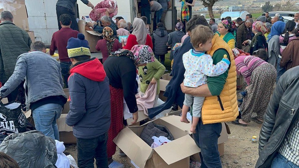 Villagers at a refugee camp receiving the aid