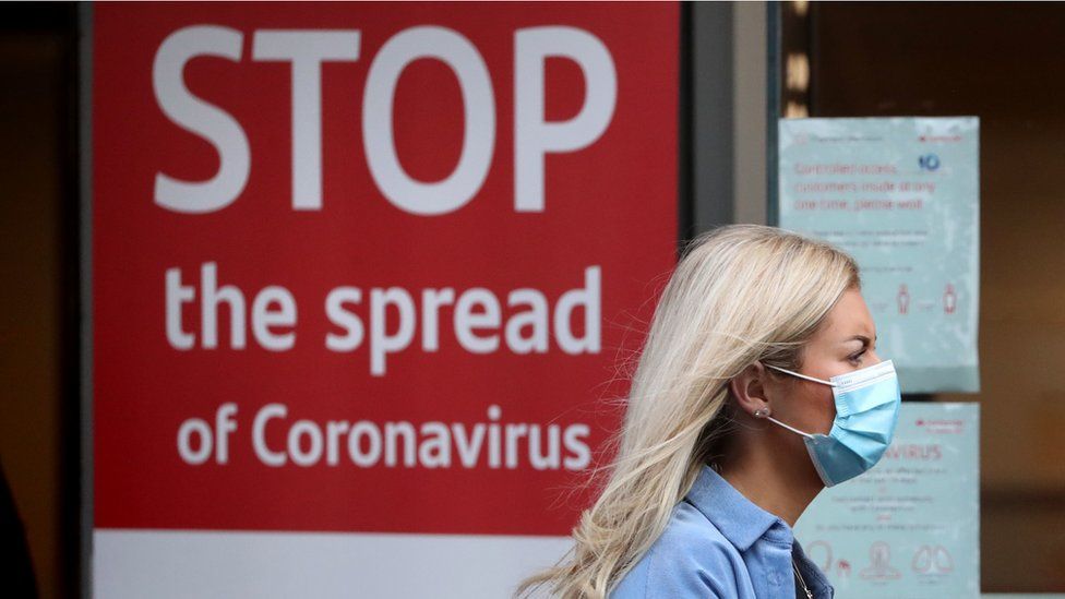 Woman wearing face mask outside hospital