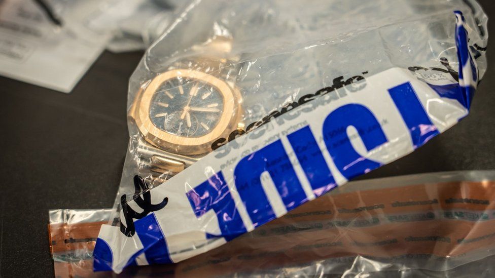Assets seized by Merseyside Police, shown is a gold watch in a police evidence bag