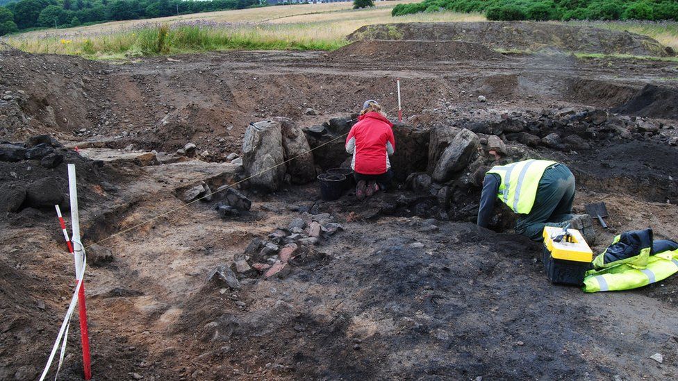 Archaeologists Sam Williamson and Steve Worth at work excavating a Bronze Age burnt mound