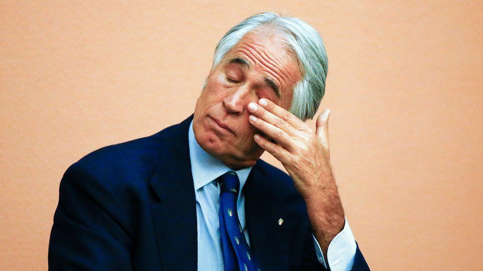 Italy"s Olympic Committee chief Malago wipes his tears at the end of his speech