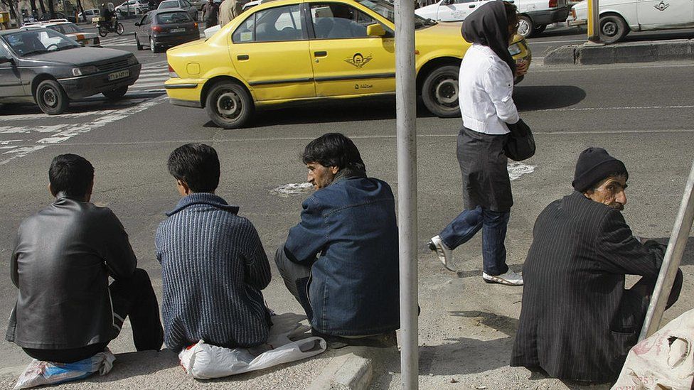 Men waiting by roadside for work, Tehran (file photo)