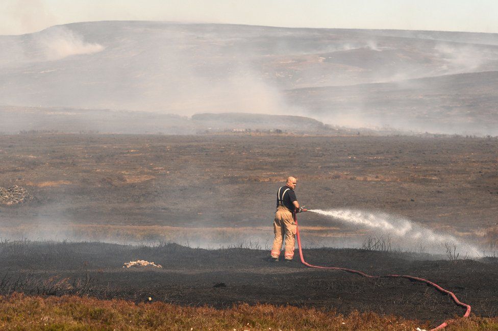 A firefighter on Saddleworth Moor