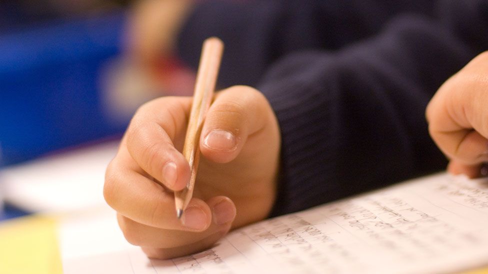 schoolchild holding a pencil