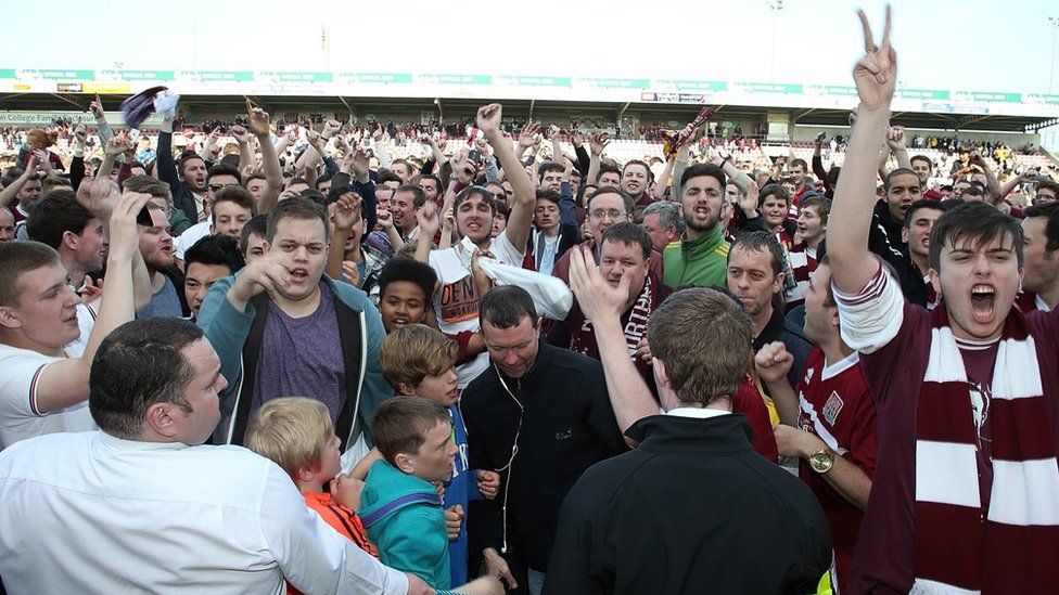 Northampton Town fans celebrate survival after beating Oxford