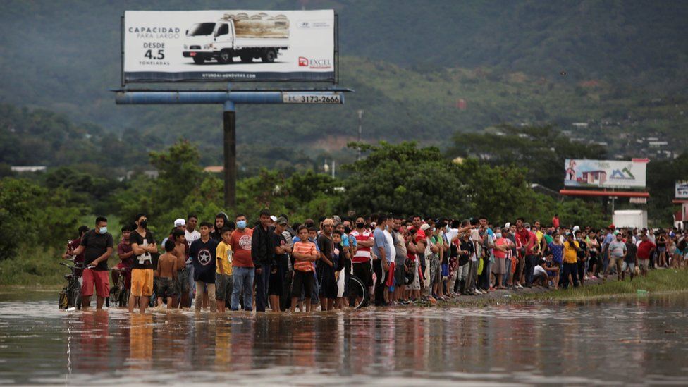 People look at a flooded street during the passage of Storm Eta, in Pimienta, Honduras November 5, 2020