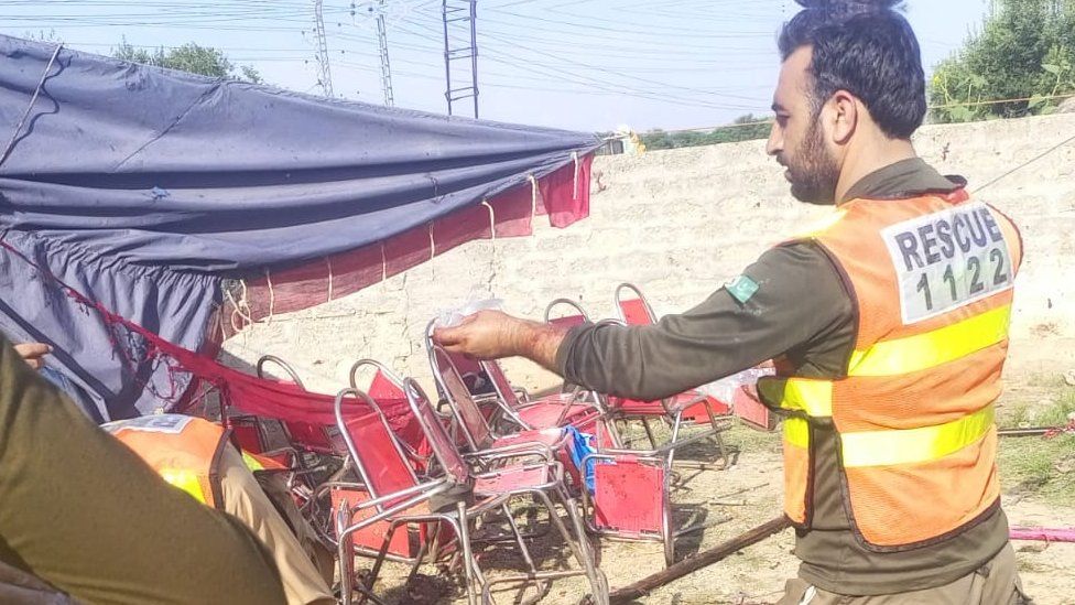 Damaged chairs and rescue workers astatine  the scene