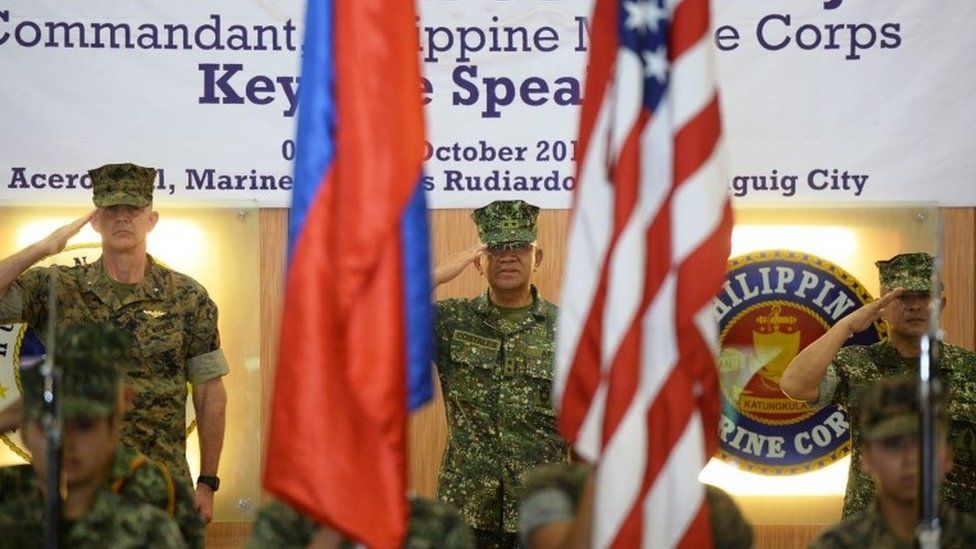 US marines Brigadier General John Jansen (L), Philippines marines Major General Andre Costales (C) and Brigadier General Maximo Ballesteros salute during the opening ceremony of the Amphibious Landing Exercise (PHIBLEX) at the marines headquarters in Manila on October 4, 2016.