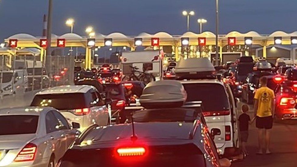 Cars are stuck in queues at the Port of Calais as night time approaches