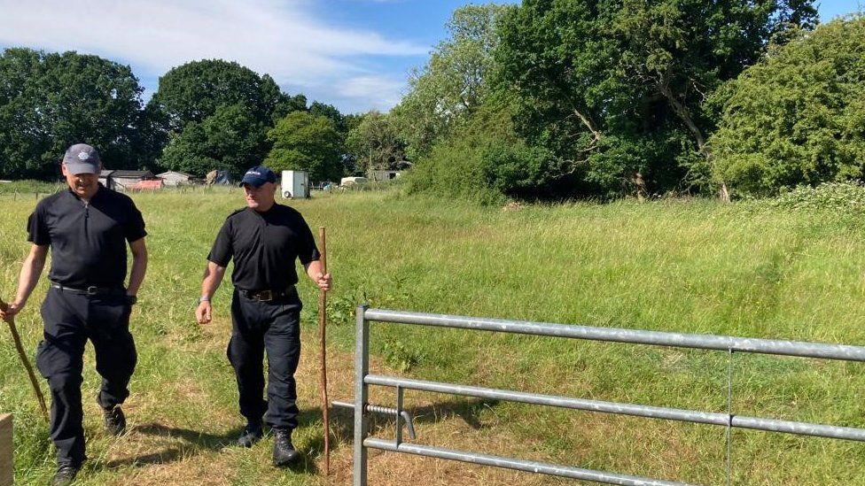 Two police officers at search site in field