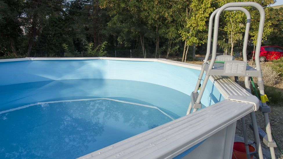 An above ground metal framed swimming pool