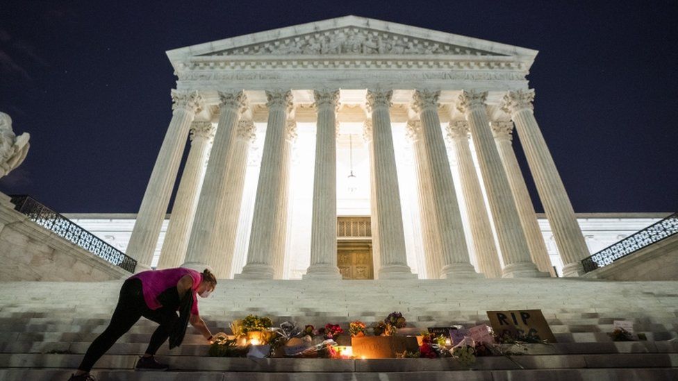 Mourners lay flowers outside the Supreme Court after Ginsburg's death