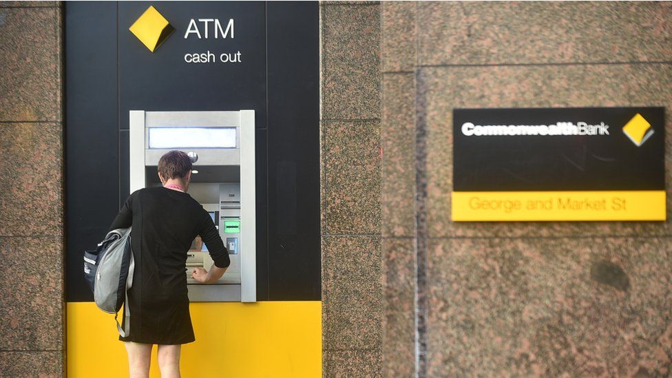 A woman using a Commonwealth Bank ATM