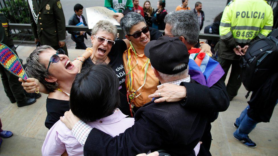 LGBT rights activist celebrate a Constitutional Court decision to give gay couples marriage rights, outside the Justice Palace in Bogota, Colombia.