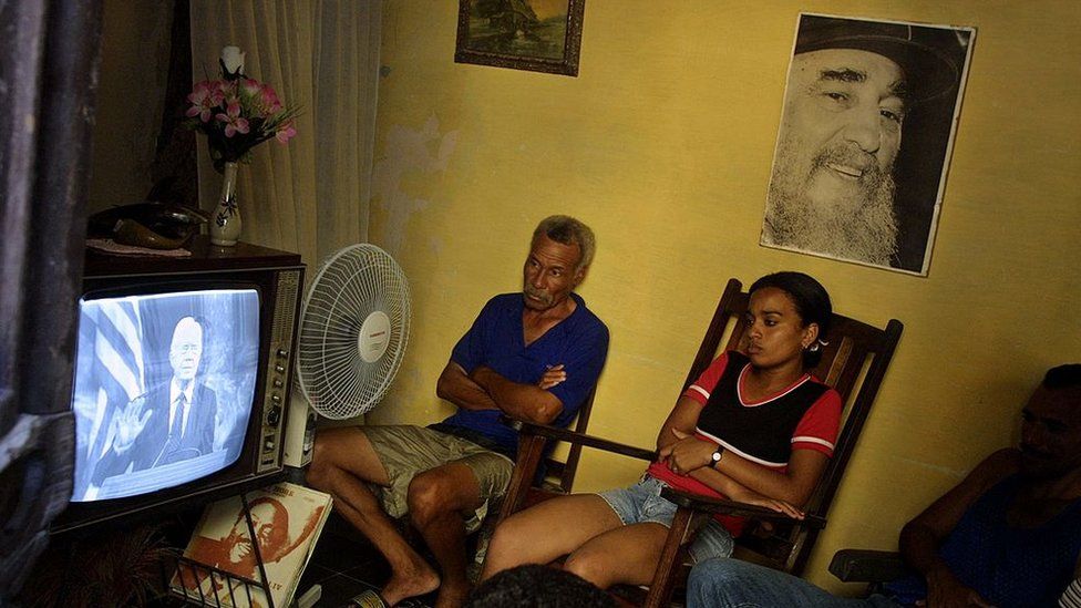 A Cuban family watch at their home a live televised address by former President Jimmy Carter who speaks in Spanish to the Cuban people at the University of Havana on May 14, 2002 in Havana, Cuba.