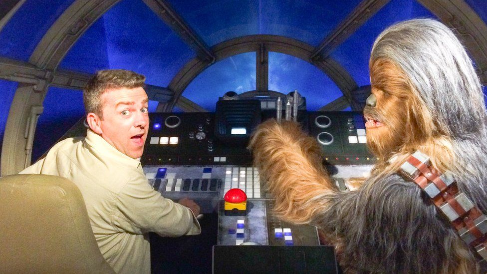 Journalist Chris Smith in the cockpit of the Millennium Falcon
