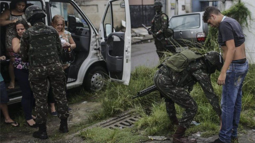 A soldier controls passers-by in Rio de Janeiro, Brazil, 23 February 2018.
