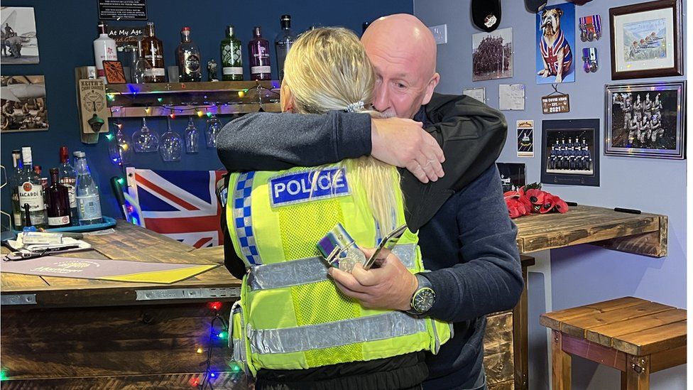 Mr Eamer hugging the policewoman who returned the medals
